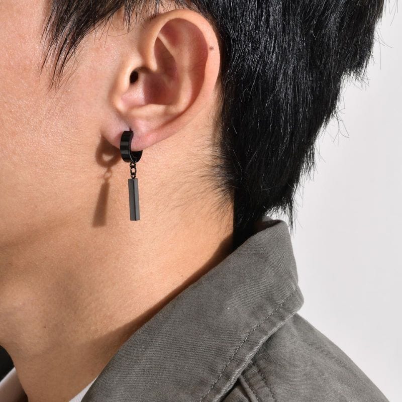 Boucle d’oreille pendante homme noire en acier inoxydable portée à l’oreille