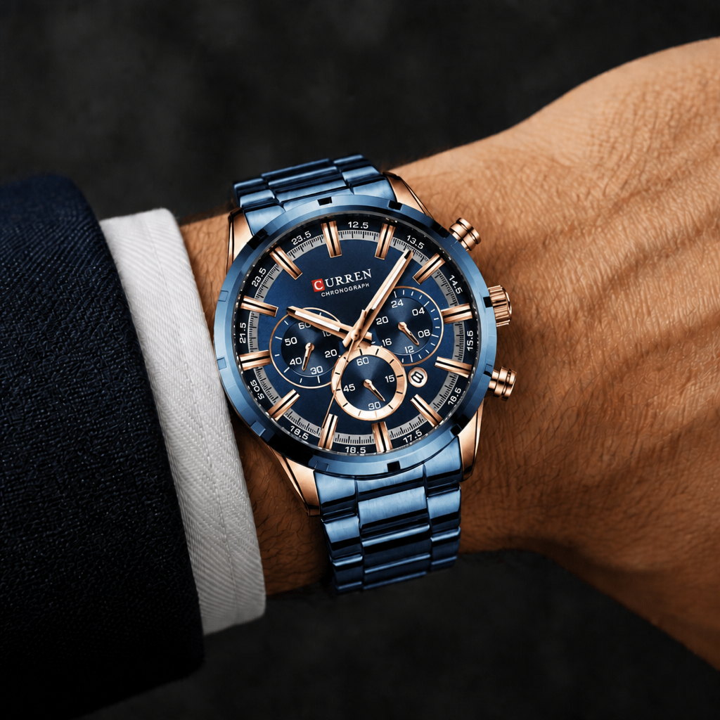 Grosse montre homme ronde chronographe bleue portée au poignet sous une manchette de chemise