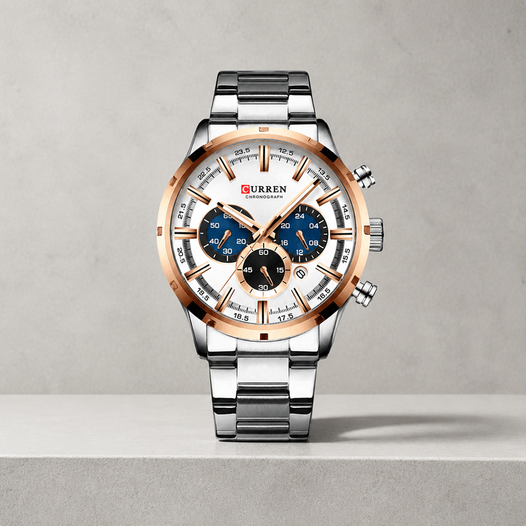 Grosse montre homme ronde chronographe à cadran blanc et liseré or rose sur dalle de béton
