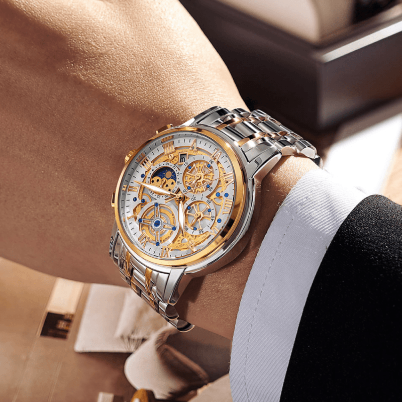 Montre Squelette Chronographe Luxe or au poignet d'un homme en costume