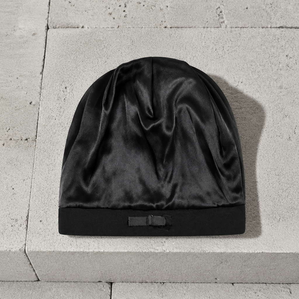 Bonnet noir retourné : doublure satinée noire et patte de réglage sur le bord