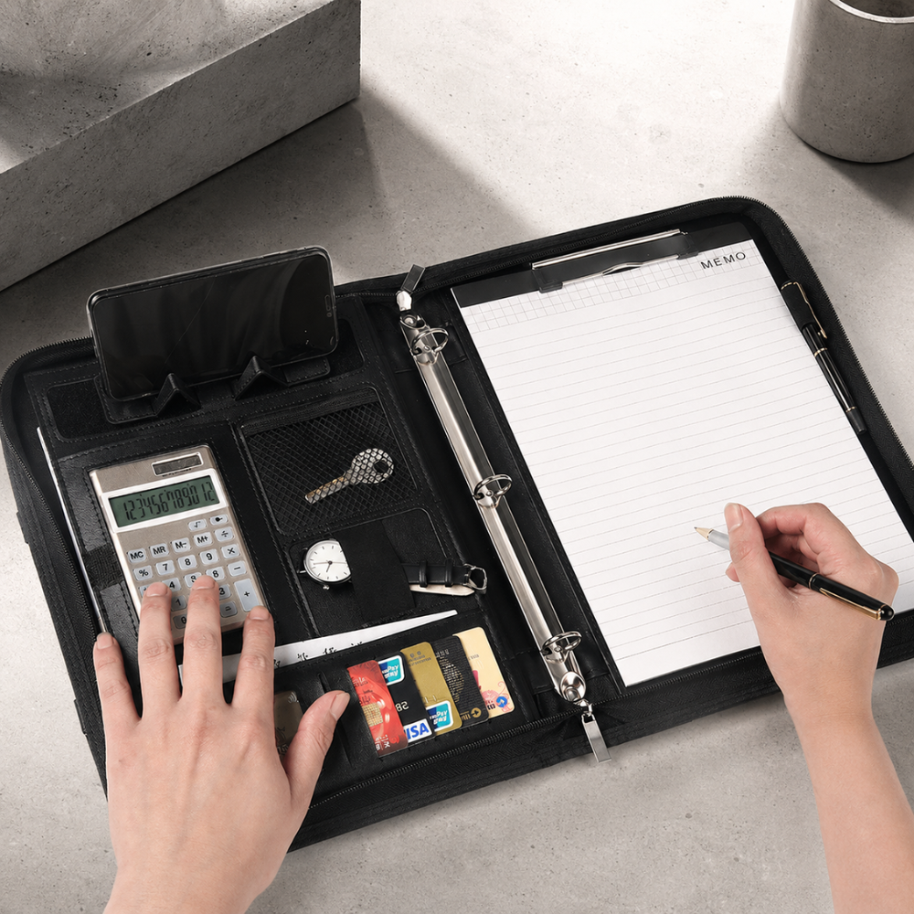 Classeur porte-document en usage sur un bureau : calculatrice, bloc-notes MEMO et prise de notes